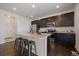 Modern kitchen features stainless steel appliances, granite counters, and dark cabinetry at 9608 Albion Ln, Thornton, CO 80229