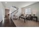 Bright living room with a cozy seating arrangement and staircase, showcasing a modern and inviting atmosphere at 9608 Albion Ln, Thornton, CO 80229