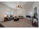 Spacious living room with modern fireplace, stylish furniture, and natural light, creating a warm ambiance at 9608 Albion Ln, Thornton, CO 80229