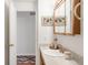 Bathroom featuring a vanity, mirror, and an open doorway showing patterned flooring at 1812 24Th Ave, Longmont, CO 80501