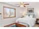 Bright bedroom featuring a ceiling fan, wood floors, and a window with a view at 1812 24Th Ave, Longmont, CO 80501