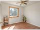 Bedroom with wood floors, natural light, and views from the framed window at 1812 24Th Ave, Longmont, CO 80501