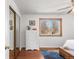 Bedroom with hardwood floors, a mirrored closet, and a sunlit window at 1812 24Th Ave, Longmont, CO 80501