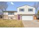 Charming two-story home featuring a purple front door, brick accents, and an attached two-car garage at 1812 24Th Ave, Longmont, CO 80501