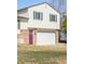 Two-story home with a two-car garage, brick accents and a lovely purple front door at 1812 24Th Ave, Longmont, CO 80501