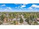 Wide aerial shot of a residential area with tree-lined streets and scattered clouds above at 295 E Amherst Ave, Englewood, CO 80113