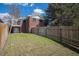 Spacious backyard featuring a lawn, wooden fence and brick home with upper level balcony at 295 E Amherst Ave, Englewood, CO 80113