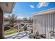Outdoor seating and decor on a balcony with white railings overlooking a neighborhood on a sunny day at 295 E Amherst Ave, Englewood, CO 80113