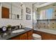 Well-appointed bathroom with granite countertop, bathtub, and tiled shower surround at 295 E Amherst Ave, Englewood, CO 80113