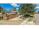 Brick house with a long driveway leading to a detached garage and fenced backyard at 295 E Amherst Ave, Englewood, CO 80113