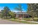 Charming single-story brick home with well-manicured landscaping and mature trees enhancing curb appeal at 295 E Amherst Ave, Englewood, CO 80113