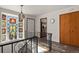 Staircase landing with stained glass window and views to updated kitchen at 295 E Amherst Ave, Englewood, CO 80113