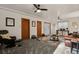 Spacious living room featuring plush carpet, a cozy leather chair, and a stylish area rug at 295 E Amherst Ave, Englewood, CO 80113