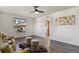 Bright living room with modern ceiling fan, neutral paint, and elegant decor at 295 E Amherst Ave, Englewood, CO 80113