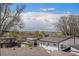 Residential rooftops with distant mountain views under a blue sky filled with fluffy white clouds at 295 E Amherst Ave, Englewood, CO 80113