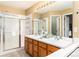 Bright bathroom features double sinks and a walk-in shower at 375 Aspenwood Ct, Lafayette, CO 80026