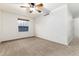 Neutral bedroom features a window, ceiling fan, and neutral carpet at 375 Aspenwood Ct, Lafayette, CO 80026