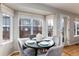 Sunny dining area features a round table, four chairs, and a charming bay window at 375 Aspenwood Ct, Lafayette, CO 80026