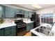 Bright kitchen featuring stainless steel appliances, dark green cabinets, and light countertops at 375 Aspenwood Ct, Lafayette, CO 80026