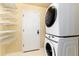 Bright laundry area includes stacked washer/dryer and shelving for optimal organization and efficiency at 375 Aspenwood Ct, Lafayette, CO 80026