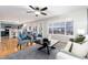 Bright living room with hardwood floors, ceiling fan, and a view of the kitchen and dining area at 375 Aspenwood Ct, Lafayette, CO 80026