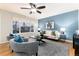 Cozy living room with hardwood floors, light-blue walls, large windows, and comfortable seating at 375 Aspenwood Ct, Lafayette, CO 80026