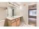 Bright bathroom featuring a single sink vanity and a large mirror with Hollywood-style lighting at 1121 W 112Th Ave # C, Denver, CO 80234