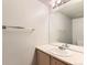 Bathroom featuring a modern sink, vanity, and a large mirror with lighting at 1121 W 112Th Ave # C, Denver, CO 80234