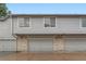 Multi-unit exterior featuring garages with brick accents and neutral siding for a clean aesthetic at 1121 W 112Th Ave # C, Denver, CO 80234