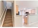 The kitchen is connected to the staircase with views of the kitchen appliances and counters at 1121 W 112Th Ave # C, Denver, CO 80234