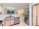 Well-lit kitchen featuring stainless steel appliances and a view of the dining area at 1121 W 112Th Ave # C, Denver, CO 80234