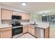 Bright kitchen with stainless steel appliances, neutral cabinets and a view to the dining area at 1121 W 112Th Ave # C, Denver, CO 80234