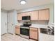 Functional kitchen with stainless steel appliances and neutral colored cabinets at 1121 W 112Th Ave # C, Denver, CO 80234