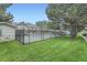 Fenced community pool surrounded by lush greenery, perfect for relaxation and recreation at 1121 W 112Th Ave # C, Denver, CO 80234