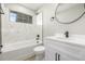 Modern bathroom with tub, shower, and sleek white vanity at 2260 S Lewiston St, Aurora, CO 80013