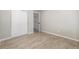 Bedroom with wood-look floors and closet with sliding doors at 2260 S Lewiston St, Aurora, CO 80013