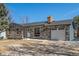Exterior elevation of a home showcasing a stone facade and attached garage at 2260 S Lewiston St, Aurora, CO 80013