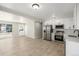 Bright kitchen features stainless steel appliances, white cabinetry, and new floors at 2260 S Lewiston St, Aurora, CO 80013