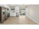 Bright eat-in kitchen featuring stainless appliances, white cabinetry, and access to backyard at 2260 S Lewiston St, Aurora, CO 80013