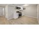 Cozy kitchenette features stainless steel appliances, white cabinets, and light wood-look flooring at 2260 S Lewiston St, Aurora, CO 80013
