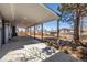 An extended patio with built-in lighting extends to the yard, with mature trees at 2260 S Lewiston St, Aurora, CO 80013