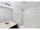 Clean bathroom with shower-tub combo, white fixtures, and a vanity with dark wood cabinets at 10211 Ura Ln # 2-207, Thornton, CO 80260