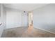 Spacious carpeted bedroom featuring a closet for storage and neutral paint throughout at 10211 Ura Ln # 2-207, Thornton, CO 80260
