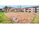 Exterior view of an apartment complex featuring a communal sandbox at 10211 Ura Ln # 2-207, Thornton, CO 80260
