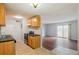 Compact kitchen flows into a living area with a sliding door to a balcony, good counter space, and neutral walls at 10211 Ura Ln # 2-207, Thornton, CO 80260