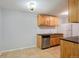 Efficient kitchen featuring stainless steel appliances, tile flooring, and wood cabinetry at 10211 Ura Ln # 2-207, Thornton, CO 80260