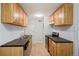 Well-lit kitchen with tiled floor, good counterspace, stainless steel appliances, and ample cabinetry at 10211 Ura Ln # 2-207, Thornton, CO 80260