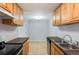 Kitchen provides tiled floor, a stainless dishwasher, and wood cabinets with good counter space at 10211 Ura Ln # 2-207, Thornton, CO 80260