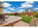 Well-maintained backyard with a stamped concrete patio, lush lawn, and wood fence at 25811 E Archer Ave, Aurora, CO 80018