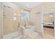 A bright bathroom with a glass-enclosed shower, soaking tub, and neutral tile at 25811 E Archer Ave, Aurora, CO 80018